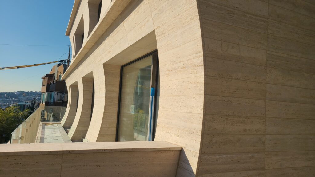 Travertine stone facade in warm beige tones on contemporary architecture